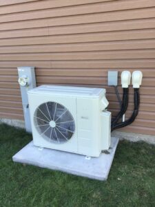 Ductless mini-split outside unit attached to wall of building