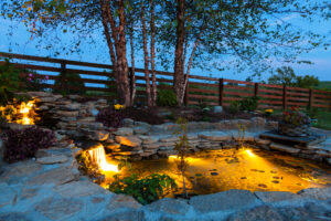 Decorative koi pond in a garden at night with lighting